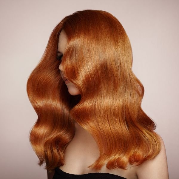 Long copper balayage hair color in waves