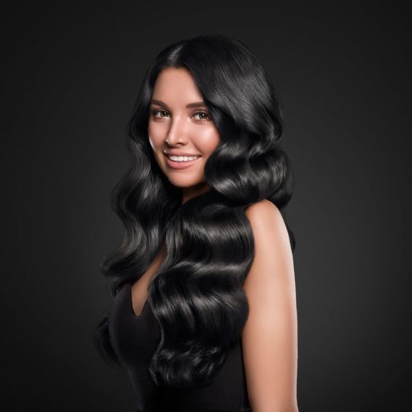 Woman with long dark wavy hair extensions