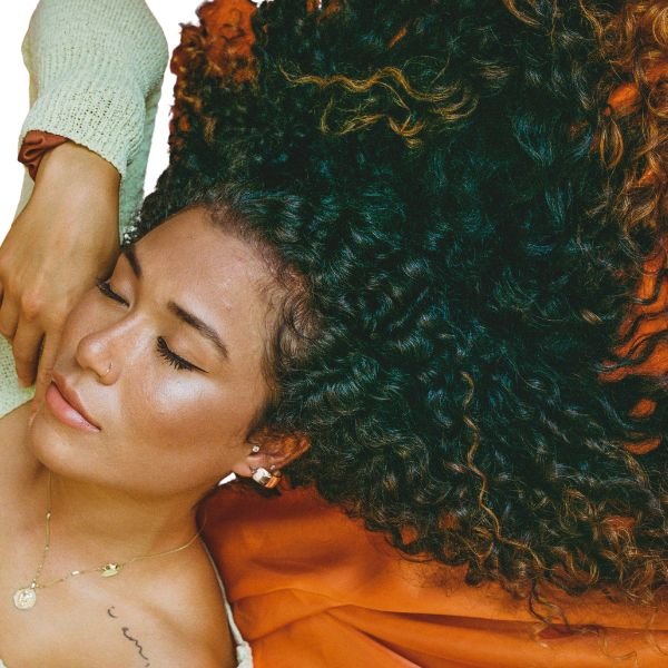 Woman with curly hair receiving a perm and smoothing treatment